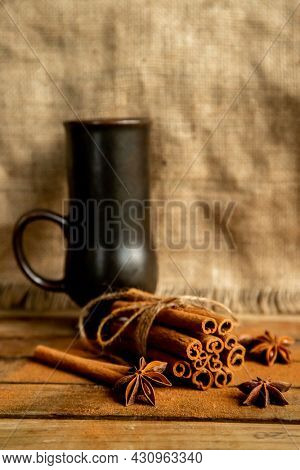 CINNAMON STICKS ON WOODEN BACKGROUND