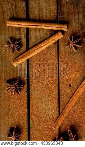 CINNAMON STICKS ON WOODEN BACKGROUND