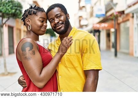 Young afircan american couple smiling happy and hugging at the city.