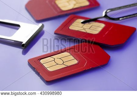 Sim Cards, Tray And Ejector On Violet Background, Closeup