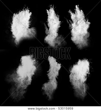 Freeze motion of white dust explosion isolated on black background