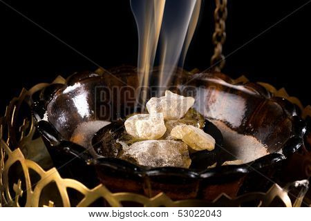 Closeup of real smoking church incense on burning charcoal 