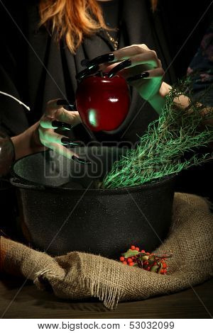  Witch in scary Halloween laboratory on dark color background
