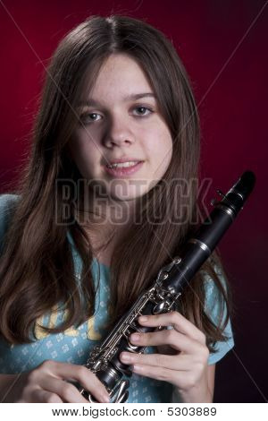 Adolescente jogador de clarinete em vermelho