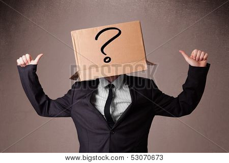 Businessman standing and gesturing with a cardboard box on his head with question mark