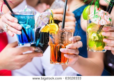 Friends drinking with barkeeper cocktails in fancy night club
