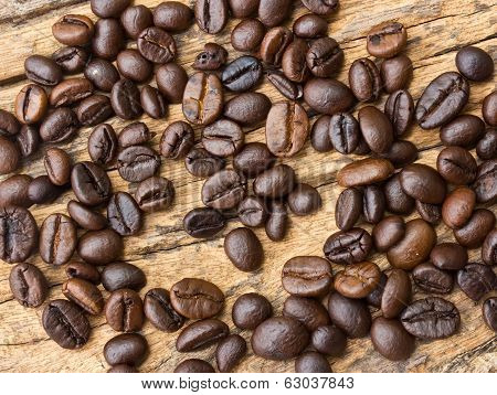 Coffee Beans  On Wood Background .
