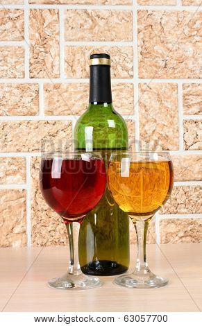 Wine bottle and glass on brick wall background