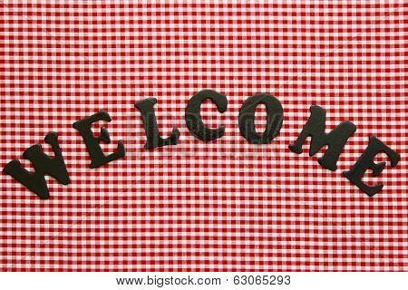 Welcome sign on red checkered (gingham) background