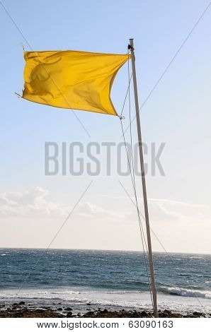 Yellow Festive Flag Waving In The Wind