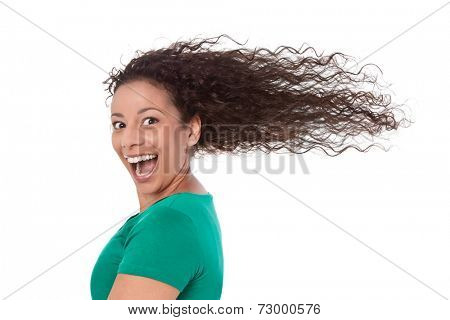 Funny girl in green with blowing hair in wind isolated.