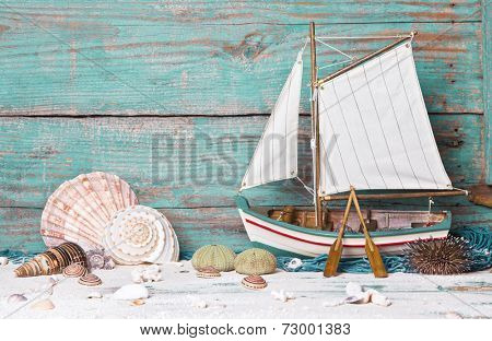Sailboat or fishing boat made of wood as nautical decoration on wooden background