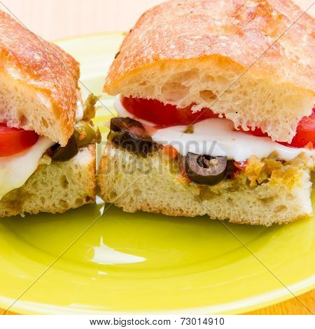 Vegetarian Hot Sandwiches With Pickle Muffaletta, Tomatoes And Melted Mozzarella Cheese
