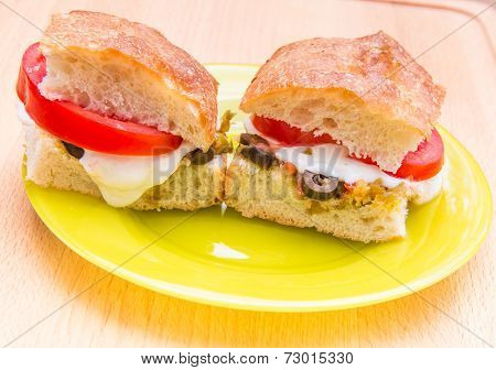 Vegetarian Hot Sandwiches With Pickle Muffaletta, Tomatoes And Melted Mozzarella Cheese. =