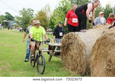 MUSKOGEE, OK - Sept. 13: Athletes jump over obstacles during the Castle Zombie Run at the Castle of Muskogee in Muskogee, OK on September 13, 2014. 