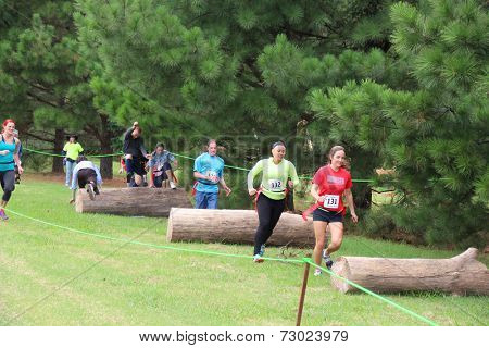 MUSKOGEE, OK - Sept. 13: Athletes jump over obstacles during the Castle Zombie Run at the Castle of Muskogee in Muskogee, OK on September 13, 2014. 