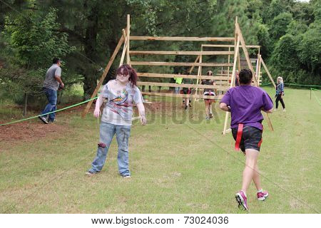 MUSKOGEE, OK - Sept. 13: Runners start at a difficult zombie-infested course during the Castle Zombie Run at the Castle of Muskogee in Muskogee, OK on September 13, 2014. 