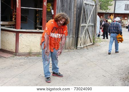 MUSKOGEE, OK - Sept. 13: A bloody zombie looks for runners during the Castle Zombie Run at the Castle of Muskogee in Muskogee, OK on September 13, 2014. 