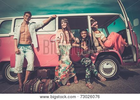 Multi-ethnic hippie friends with guitar on a road trip