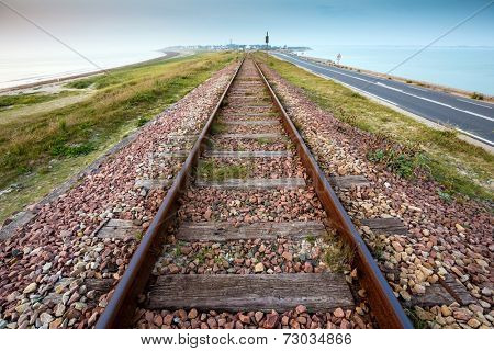 Straight railway perspective at dusk, in the Quiberon peninsula, Brittany, France