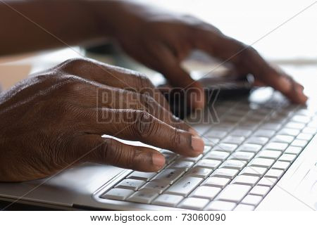 Portrait of an African American typing on the keyboard