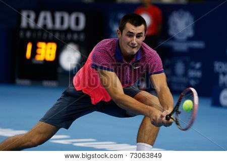 SEPTEMBER 23, 2014 - KUALA LUMPUR, MALAYSIA: Bernard Tomic of Australia makes a backhand return in his first round match at the Malaysian Open Tennis 2014 event. This is an ATP sanctioned tournament.