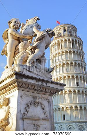 The statue of angels on Square of Miracles in Pisa and Leaning Tower, Italy 