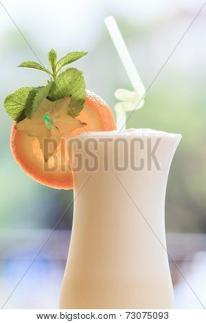 Milk cocktail with orange and carom