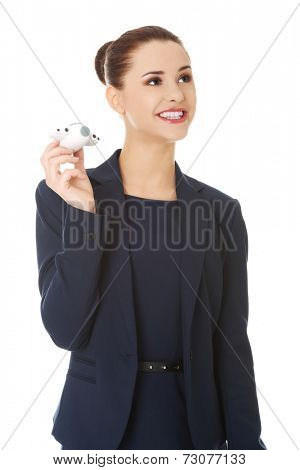 Young businesswoman with plane toy in hand