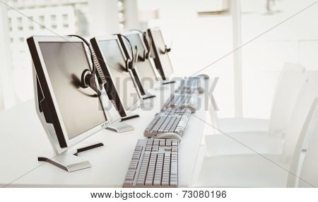 Call center computers and headsets all in a row