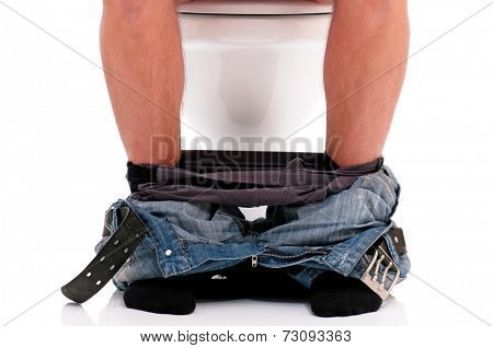 Man is sitting on the toilet bowl, on white background