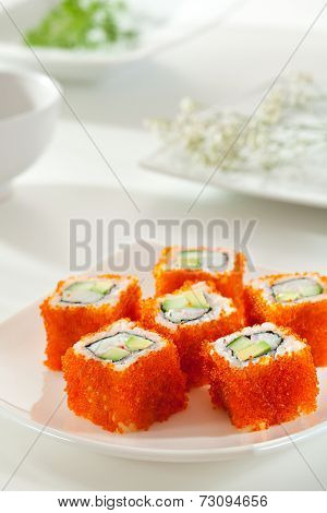 California Maki Sushi with Masago  - Roll made of Crab Meat, Avocado, Cucumber inside. Smelt roe outside