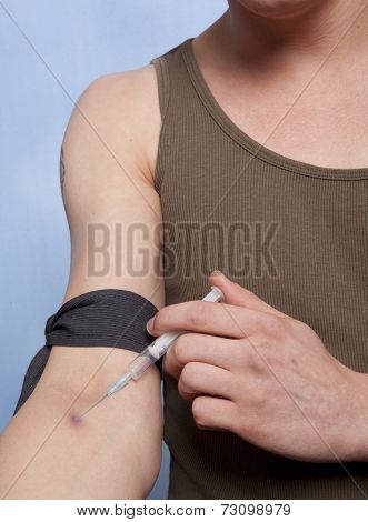 Drug addict man with syringe in action