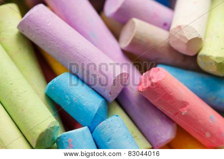 Colorful crayons for drawing on the pavement close-up