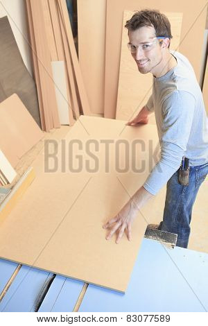 A carpenter working hard at the worksop