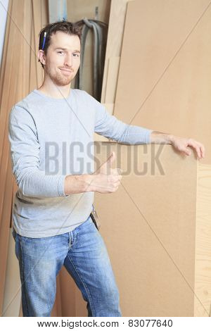 A carpenter working hard at the worksop