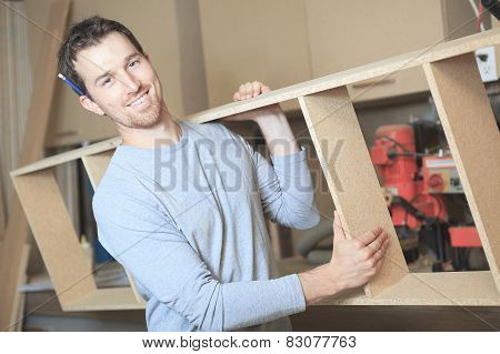 A carpenter working hard at the worksop