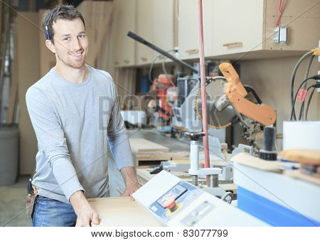 A carpenter working hard at the worksop