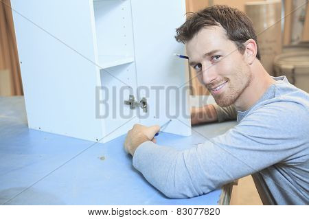 A carpenter working hard at the worksop