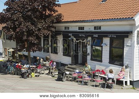 People relax in a street cafe in downtown Stavanger in Stavanger, Norway.