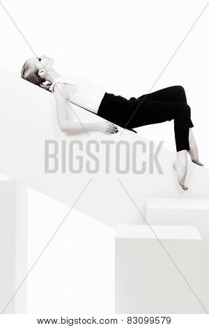 Fashionable female model posing at studio. Beauty, fashion photo. Clothing. Body care. Isolated over white.