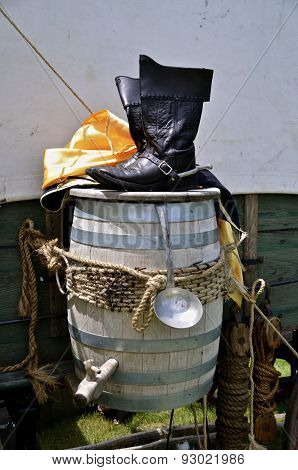 Officer's boots on water barrel