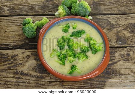 appetizing broccoli soup on dark wooden background