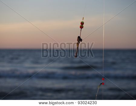 fishing-rod with bait on a sea background