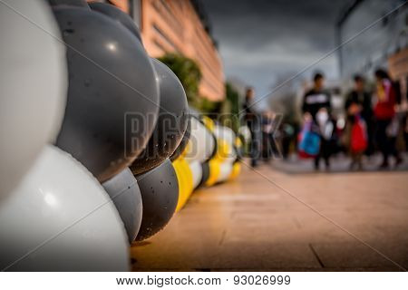 Colored balloons line the footpath