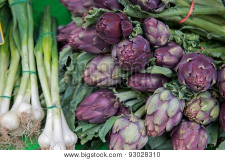 Fresh artichokes and onions at the market