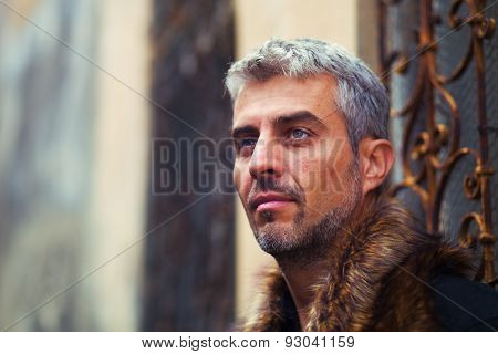 Portrait Of A Sexy Man In Wolf  Fur And Ornamental Medieval Window On Background
