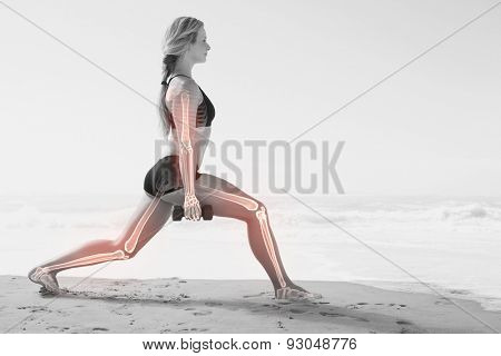 Digital composite of Highlighted bones of exercising woman