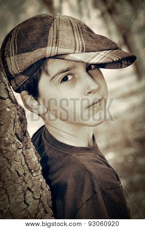 Young boy with newsboy cap playing detective