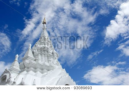 White Stucco Thai Buddhist Temple With Cloud